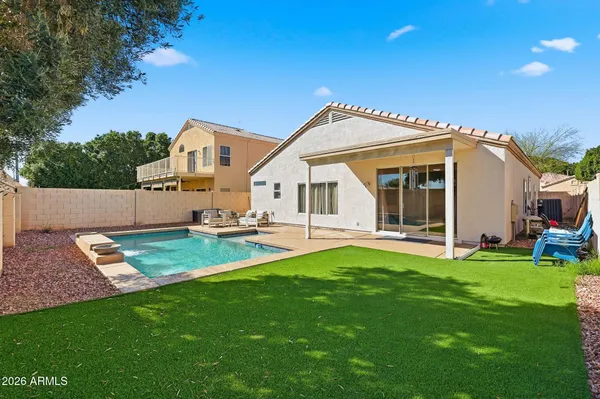 a view of a house with a yard and sitting area