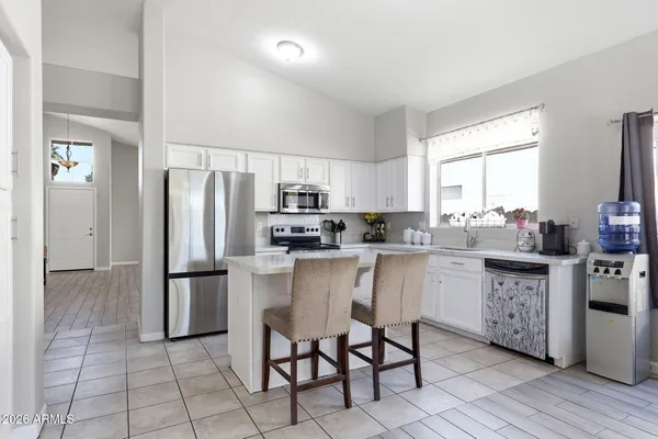 a kitchen with stainless steel appliances a refrigerator sink and stove