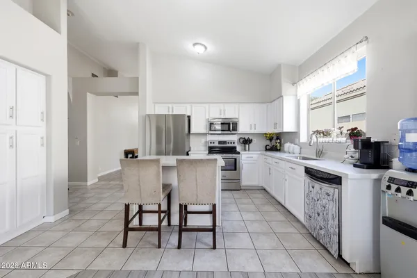 a kitchen with a sink a counter top space and stainless steel appliances