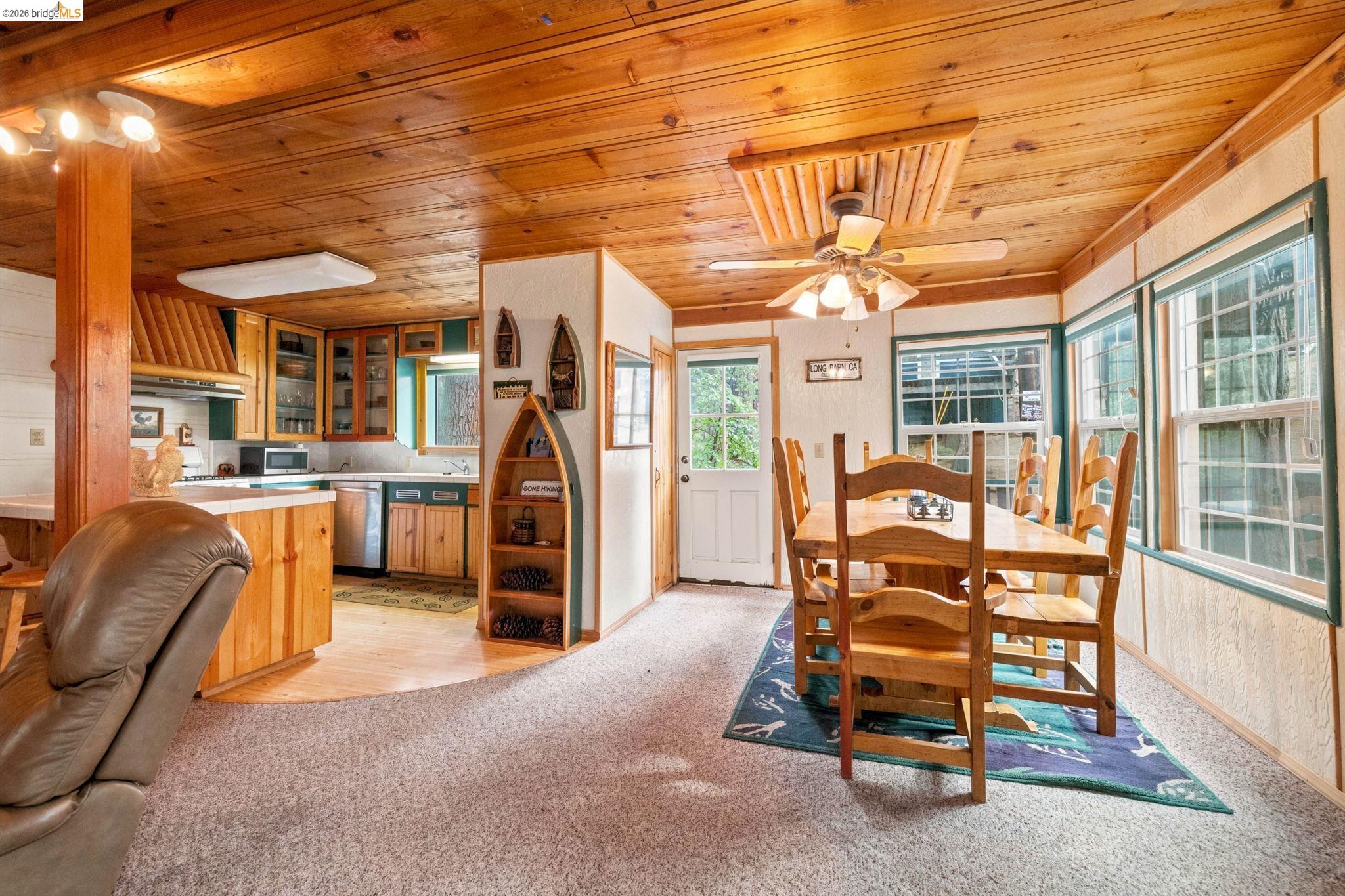 25822 Long Barn Sugar Pine Road Long Barn, CA 95335 - Photo 3 of 28 a dining room with furniture and a chandelier