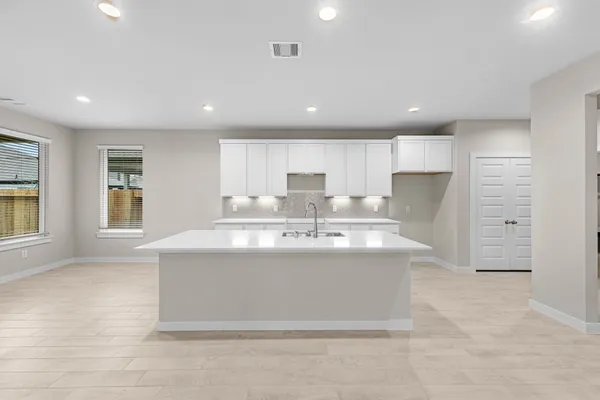 a view of kitchen with stainless steel appliances granite countertop a sink and a refrigerator
