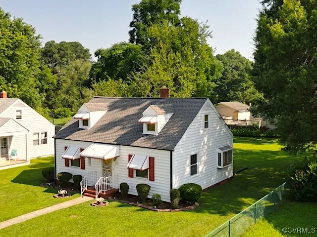 a aerial view of a house with swimming pool next to a big yard