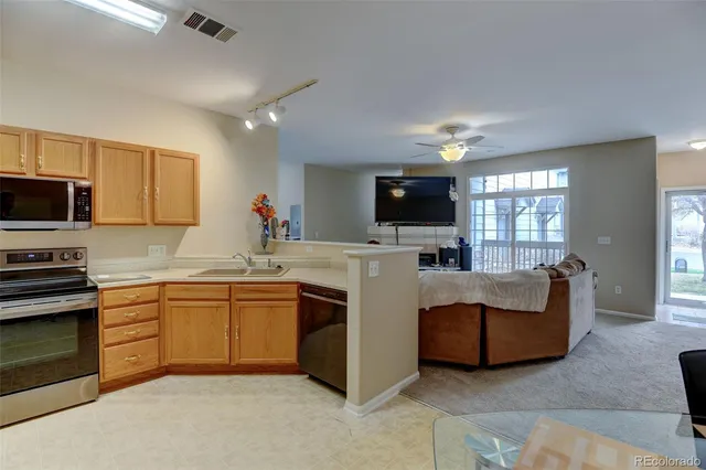 a kitchen with stainless steel appliances granite countertop a stove top oven a sink dishwasher and a microwave oven with large the oven