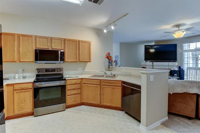 a bathroom with a sink vanity mirror and toilet
