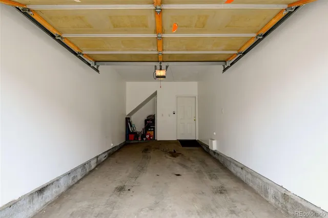 a view of a house with wooden fence and large windows