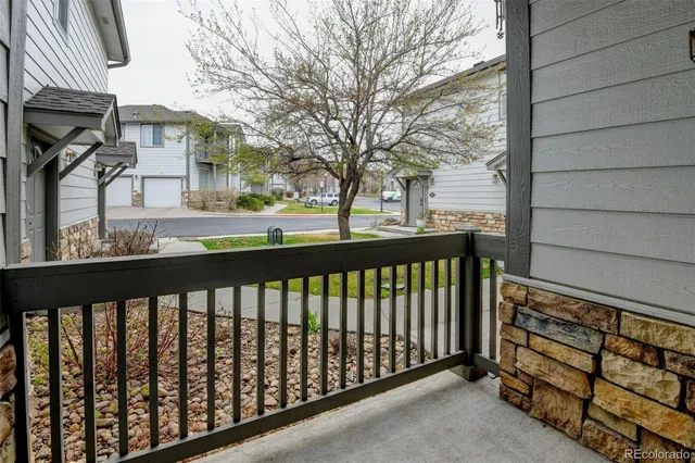 a kitchen with refrigerator and chairs
