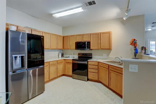 a kitchen with a stove and a refrigerator