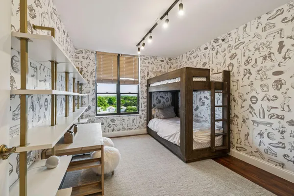 a living room with furniture a flat screen tv and a floor to ceiling window