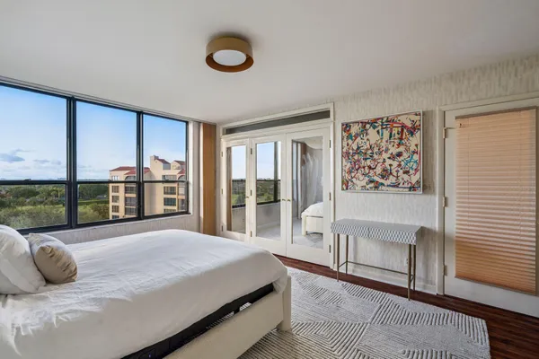 a bedroom with a large bed and a large window