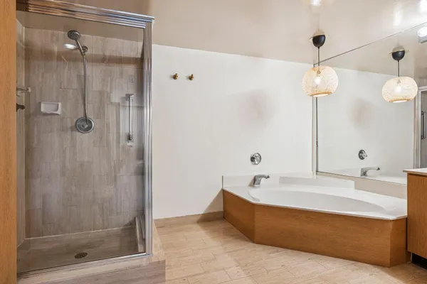 a bathroom with a tub and a shower