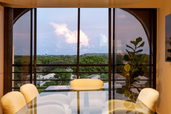 a view of a balcony with table and chairs
