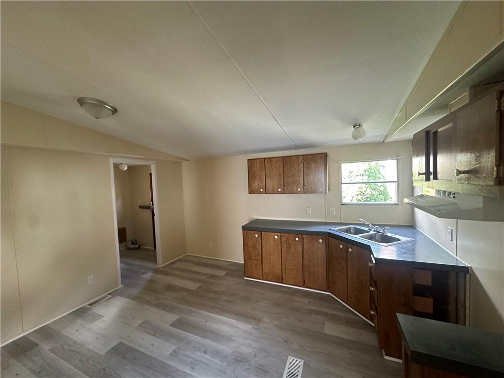204-206 Cleveland Street Elco, PA 15434 - Photo 10 of 31 a kitchen with granite countertop a sink cabinets and wooden floor
