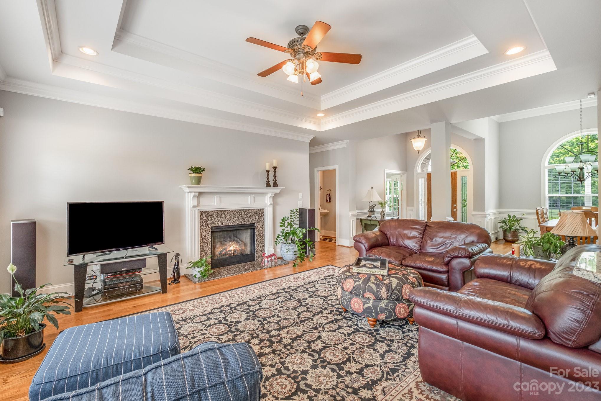 4733 Campobello Drive Monroe, NC 28110 - Photo 13 of 43 a living room with furniture a fireplace and a flat screen tv