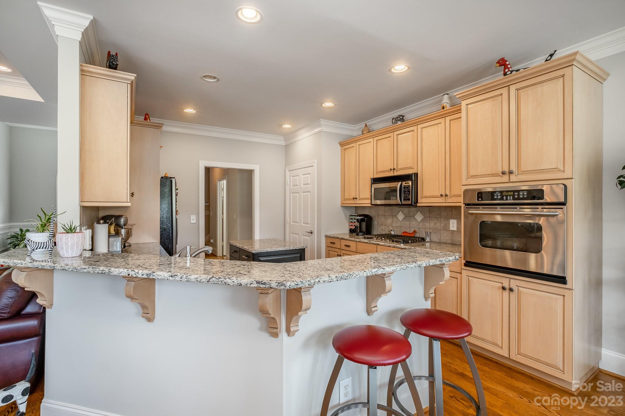 4733 Campobello Drive Monroe, NC 28110 - Photo 14 of 43 a kitchen with stainless steel appliances granite countertop a stove a sink and a microwave