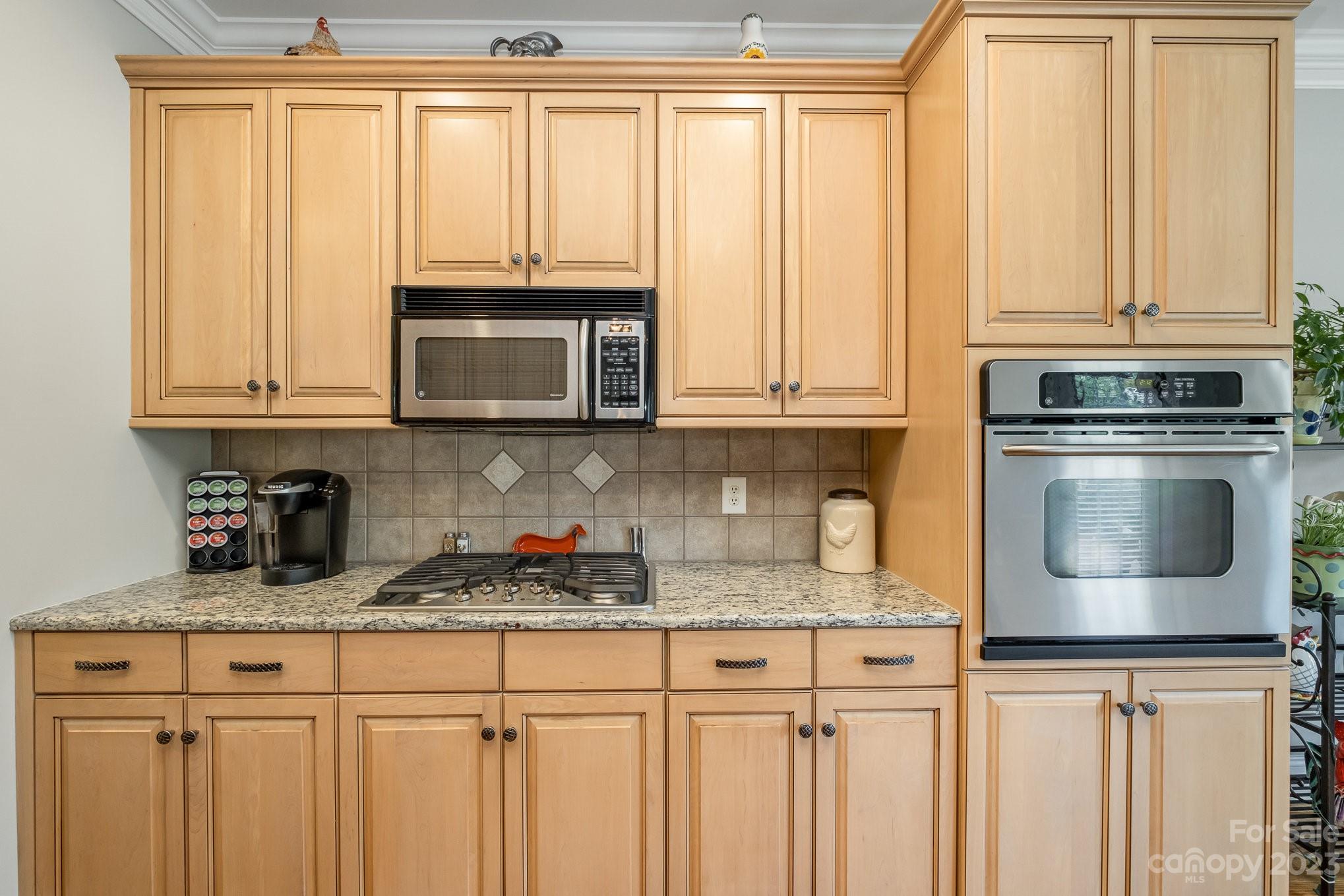 4733 Campobello Drive Monroe, NC 28110 - Photo 17 of 43 a kitchen with granite countertop white cabinets and stainless steel appliances