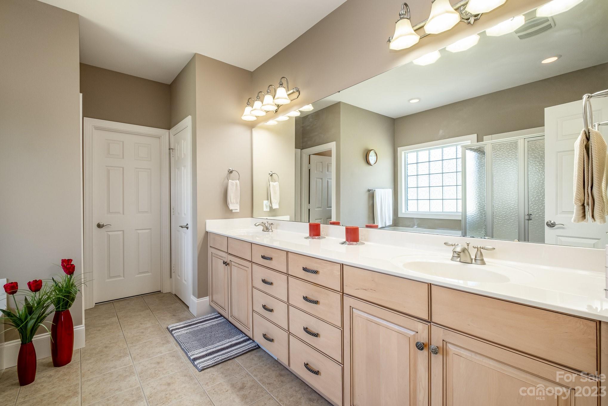 4733 Campobello Drive Monroe, NC 28110 - Photo 23 of 43 a bathroom with double vanity sinks a vanity a lamp and a mirror