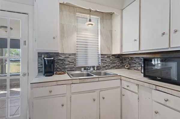 a kitchen with a sink and cabinets