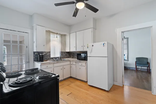 a kitchen with a stove a refrigerator and a sink
