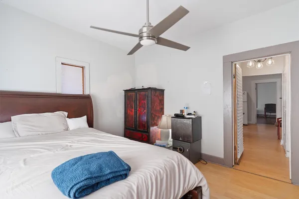 a bedroom with a bed and a chandelier