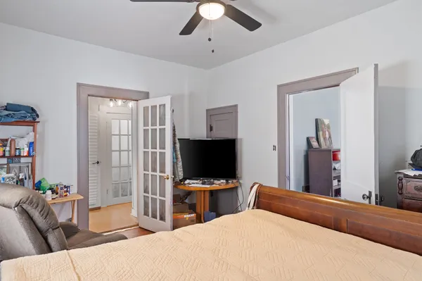 a bedroom with a bed and a flat screen tv