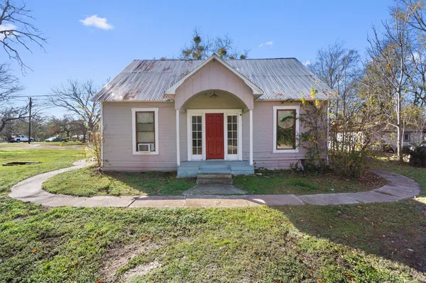 a front view of a house with garden