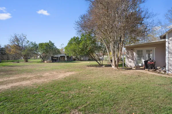 a view of a house with yard and tree s