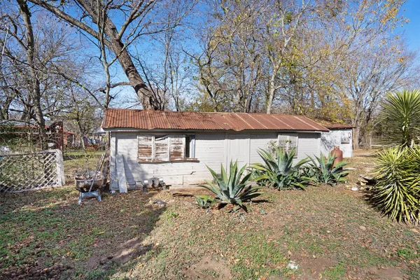 a view of a house with a yard and sitting area
