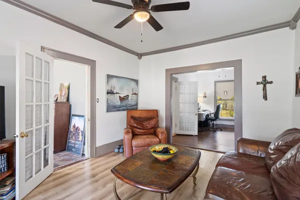 a living room with furniture and wooden floor