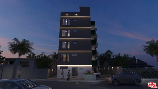 an aerial view of a house with a garden and lake view