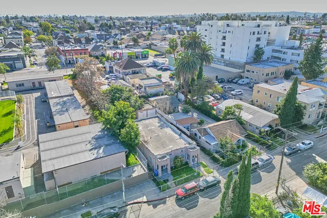 an aerial view of a house with a swimming pool outdoor seating and yard