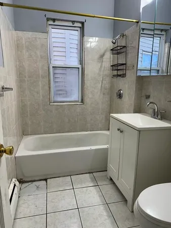a bathroom with a sink a toilet and bathtub