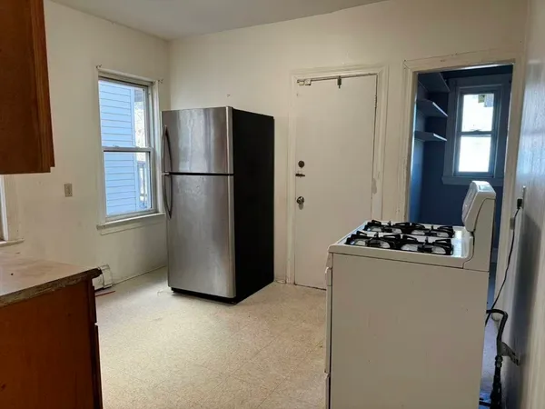 a kitchen with a refrigerator and a stove