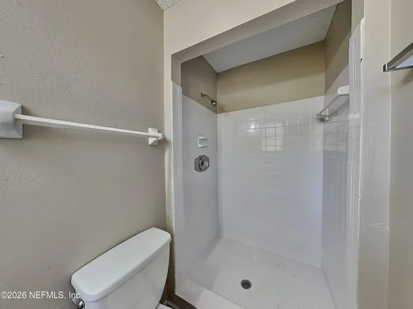 a bathroom with a shower a toilet and a sink