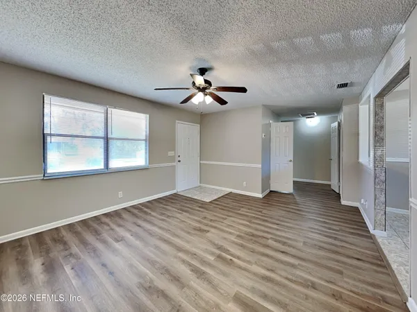 a view of an empty room with a window