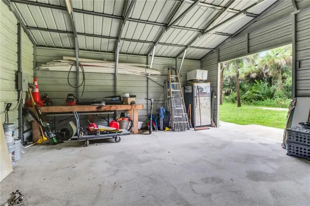 a backyard of a house with table and chairs
