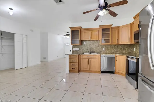 a kitchen with a stove sink and cabinets