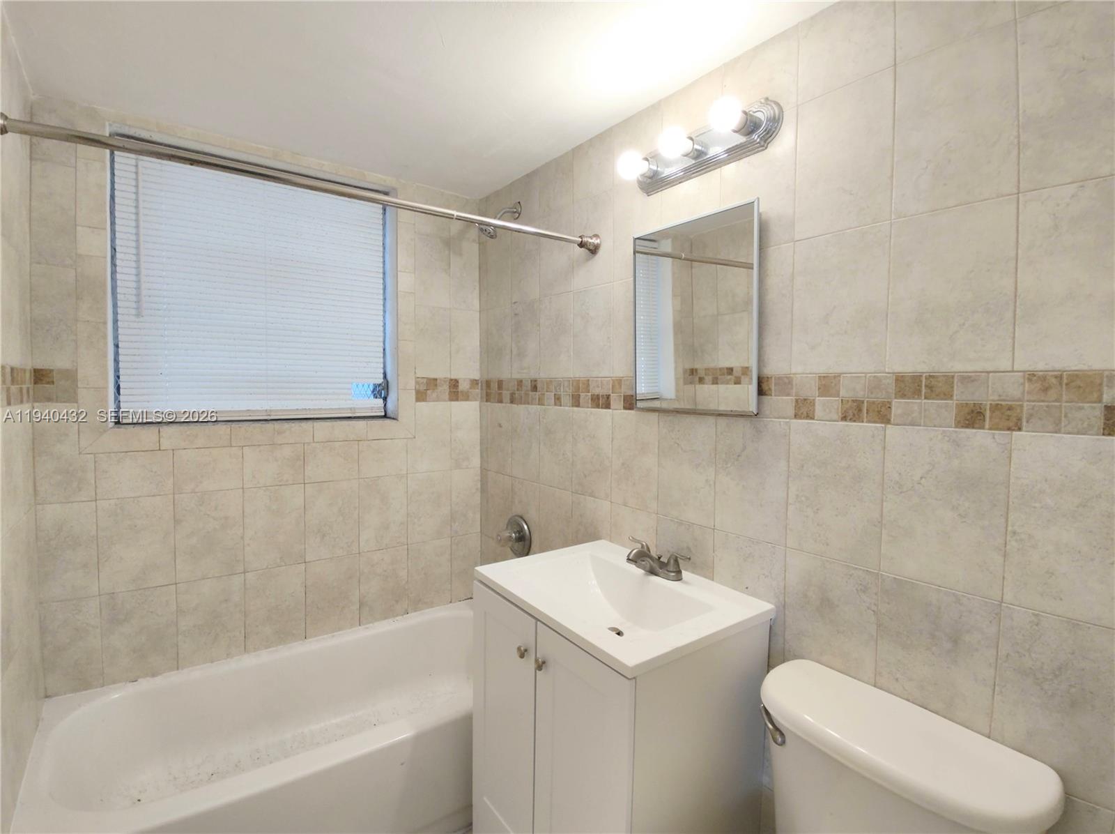 1565 Southwest 6th Street, Unit 1 Miami, FL 33135 - Photo 15 of 17 a bathroom with a sink a toilet and shower