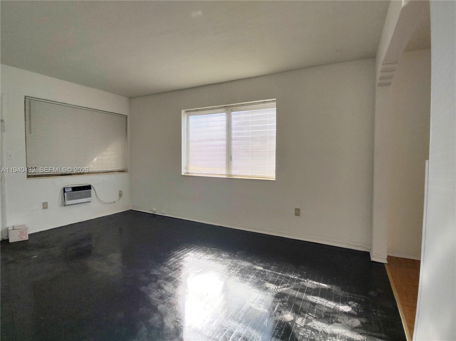 1565 Southwest 6th Street, Unit 1 Miami, FL 33135 - Photo 16 of 17 an empty room with wooden floor and windows