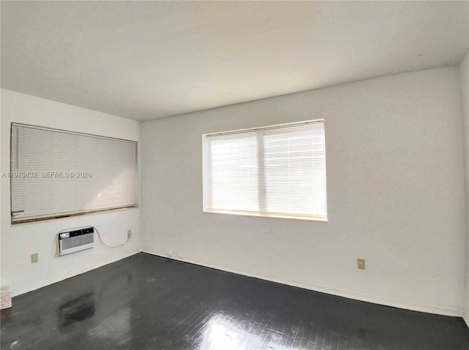1565 Southwest 6th Street, Unit 1 Miami, FL 33135 - Photo 7 of 17 an empty room with wooden floor and windows