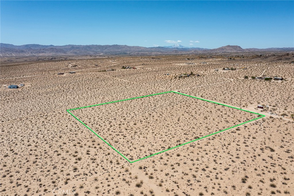 a view of an ocean beach and mountain