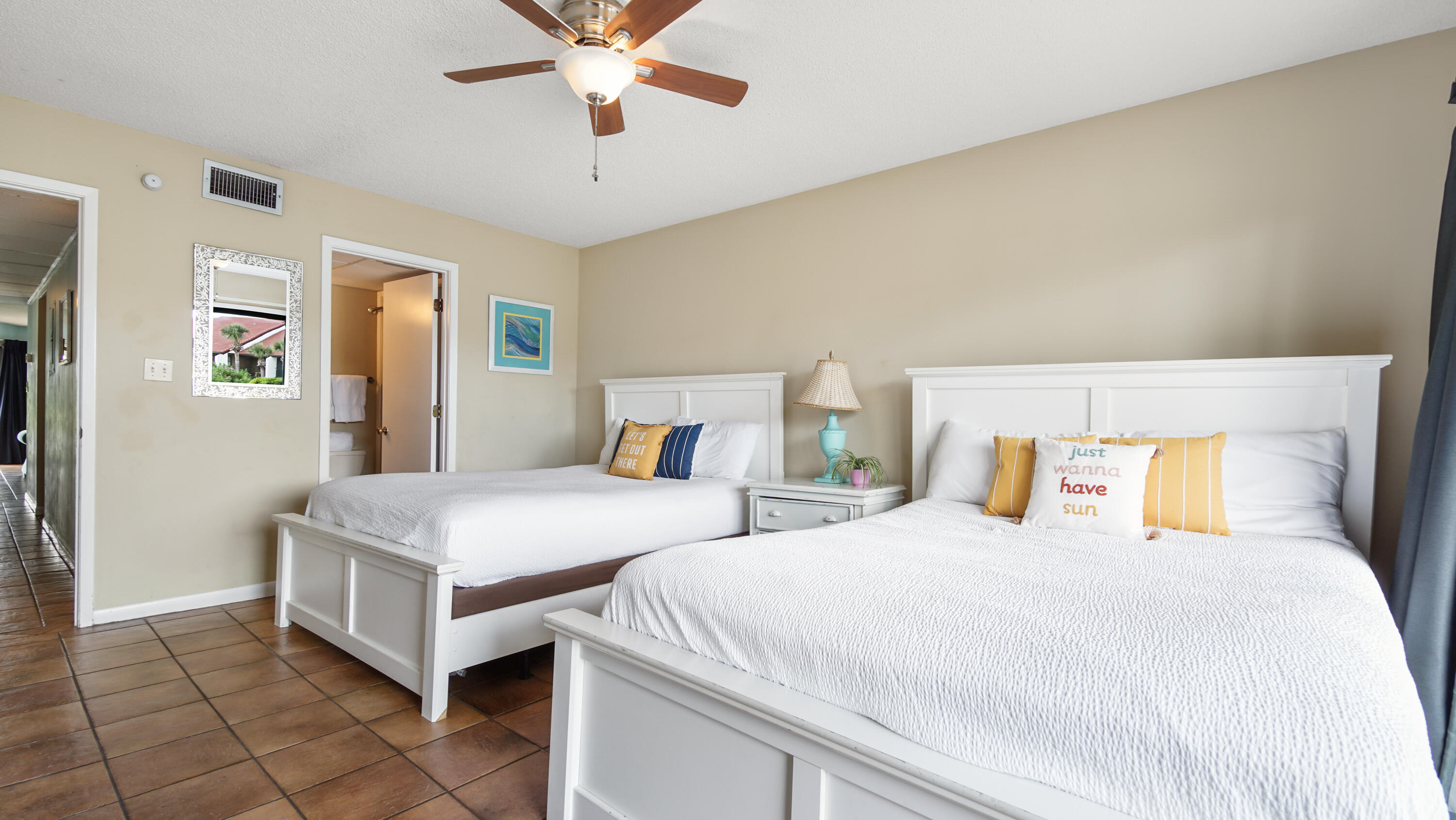 a bedroom with beds and a chandelier