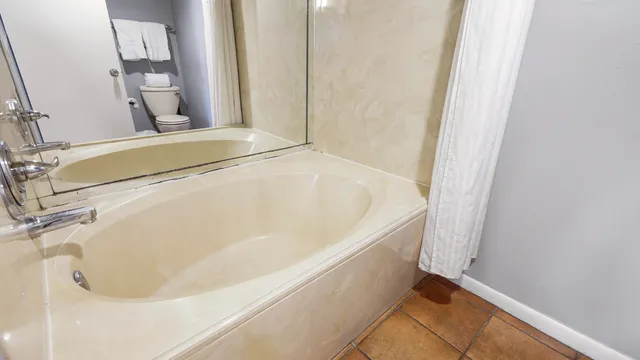 a en suite bathroom with a double vanity sink and a mirror