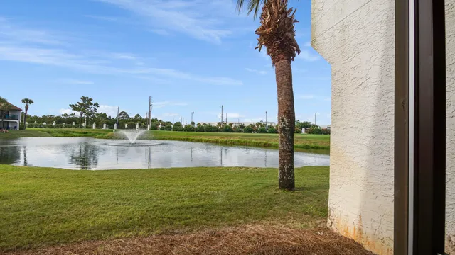 a living room with furniture kitchen view and a large window
