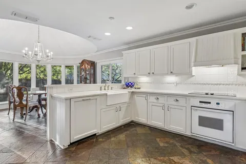 a kitchen with white cabinets and white appliances