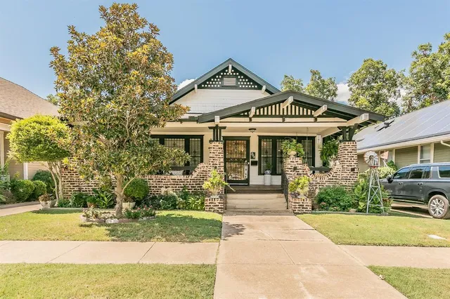 a front view of a house with garden and porch