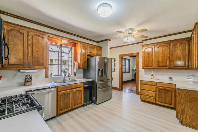 a kitchen with stainless steel appliances a stove sink and refrigerator