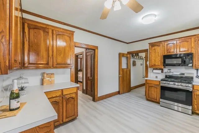 a kitchen with stainless steel appliances granite countertop a stove and a refrigerator