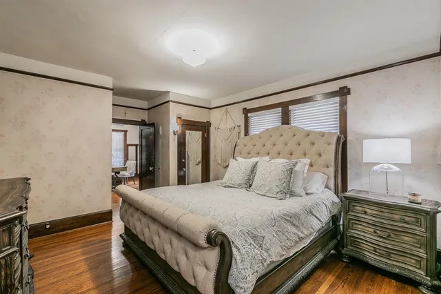 a bedroom with a bed and a night stand