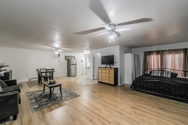 a kitchen with stainless steel appliances granite countertop a sink a stove top oven a dining table and chairs