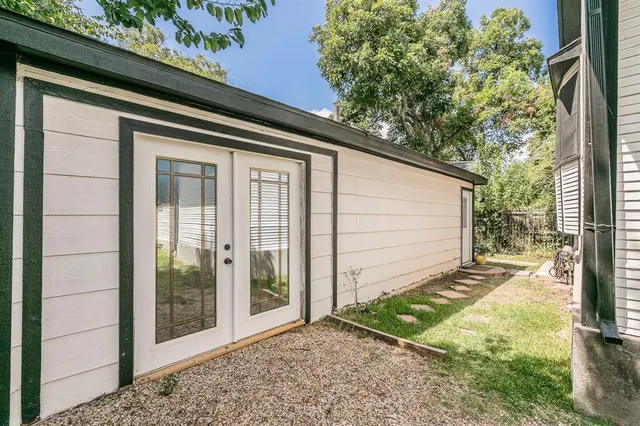 a living room with lots of furniture and view of kitchen